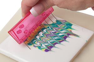 A comb being dragged through colored polyclay
